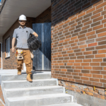 electrician-examines-construction-site-while-holding-electrical-cable-his-hand-worksite electrician-examines-construction-site-while-holding-electrical-cable-his-hand-worksite
