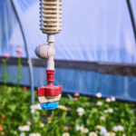 greenhouse-sprinkler-system-with-lush-plants-eye-level greenhouse-sprinkler-system-with-lush-plants-eye-level